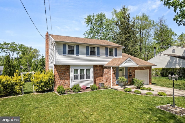colonial inspired home with a front lawn, a chimney, brick siding, an attached garage, and driveway