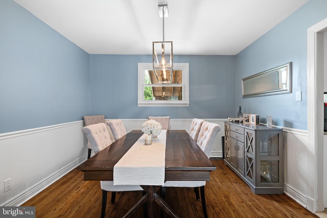 dining space with baseboards and dark wood-style flooring