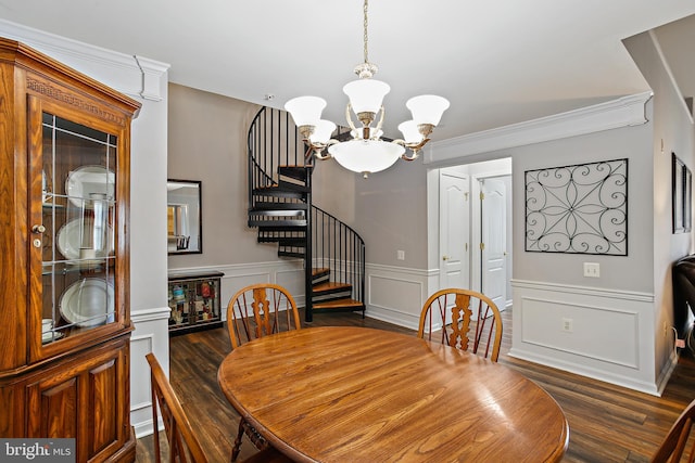 dining area featuring stairway, dark wood-style flooring, a notable chandelier, and a wainscoted wall