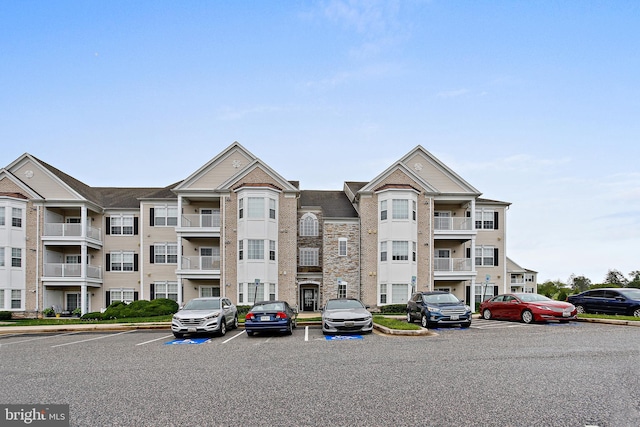 view of building exterior with uncovered parking