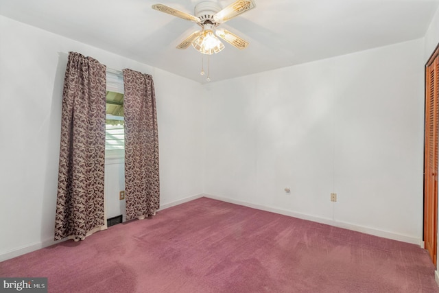 carpeted empty room featuring baseboards and ceiling fan