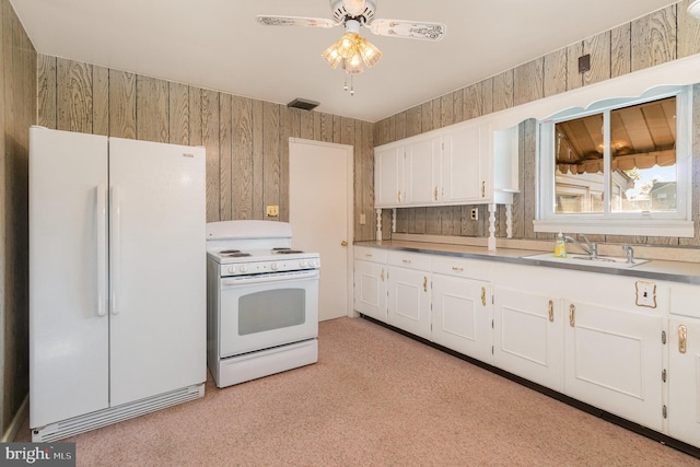 kitchen with white appliances, white cabinets, ceiling fan, and a sink