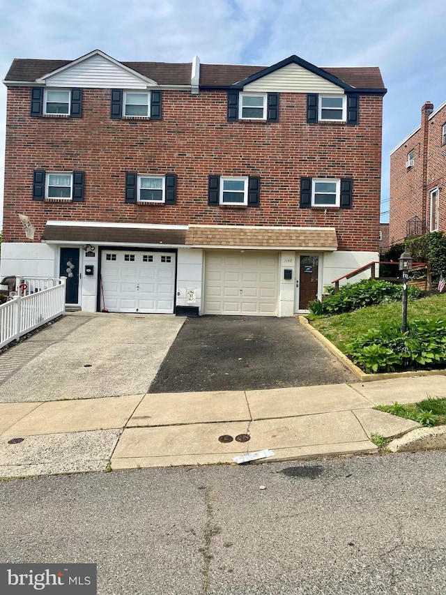 1148 Tabor Plz, Philadelphia, PA 19111 - view of property with an attached garage, driveway, and brick siding