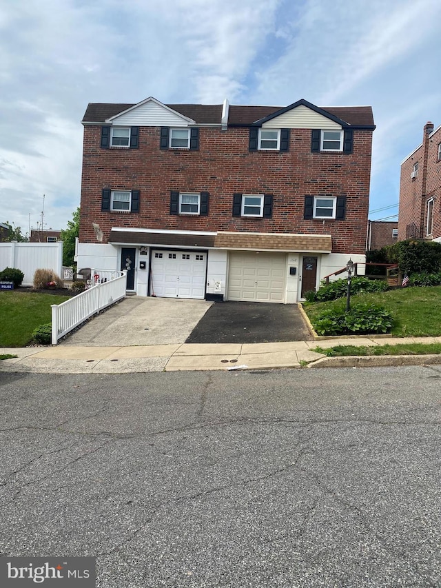 1148 Tabor Plz, Philadelphia, PA 19111 - multi unit property with brick siding, fence, driveway, and a garage