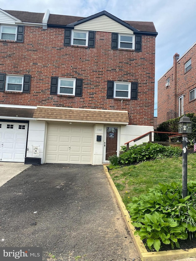 1148 Tabor Plz, Philadelphia, PA 19111 - townhome / multi-family property featuring brick siding, an attached garage, and driveway