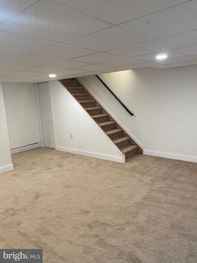 1148 Tabor Plz, Philadelphia, PA 19111 - finished below grade area featuring carpet floors, a paneled ceiling, a baseboard heating unit, and stairway