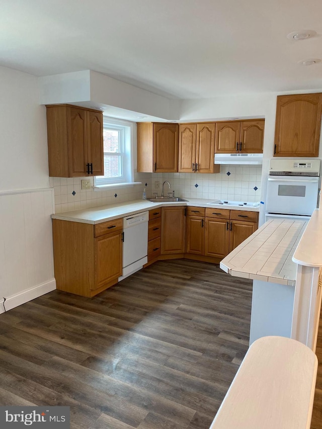1148 Tabor Plz, Philadelphia, PA 19111 - kitchen featuring white appliances, decorative backsplash, a sink, and dark wood-type flooring