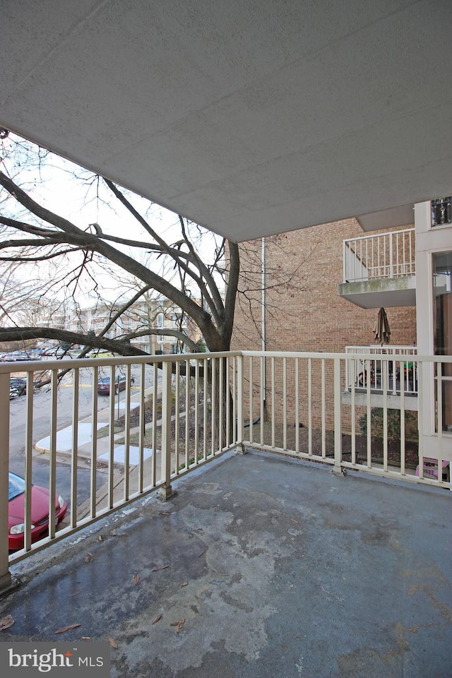 view of patio featuring a balcony