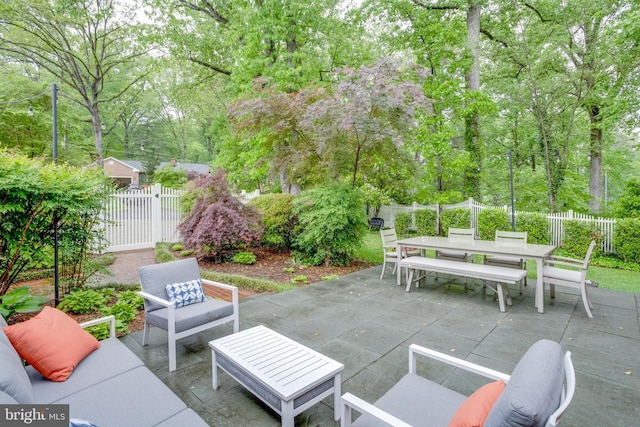 view of patio featuring outdoor dining space, an outdoor hangout area, a fenced backyard, and a gate