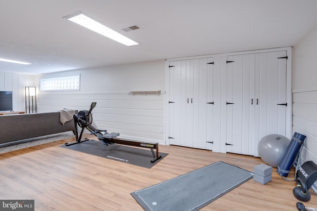 workout area with wood finished floors