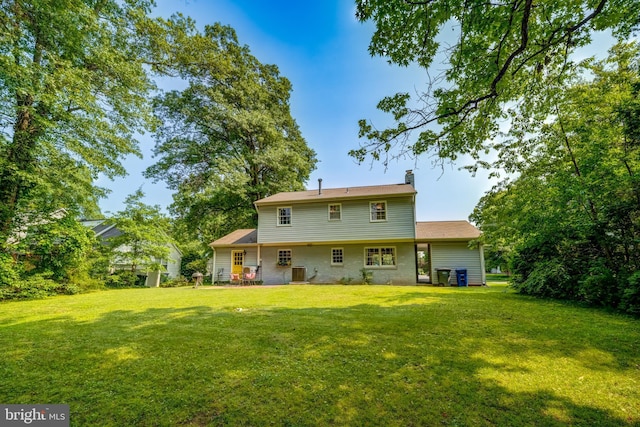 1109 Neal Dr, Alexandria, VA 22308 - back of house with a lawn, a chimney, and central AC unit