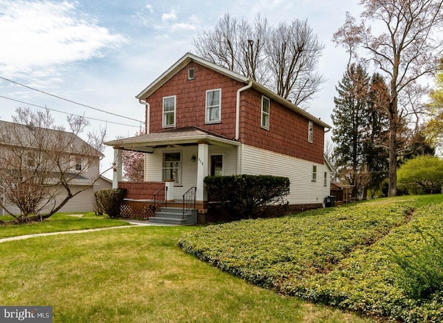 traditional-style home featuring a porch and a front lawn