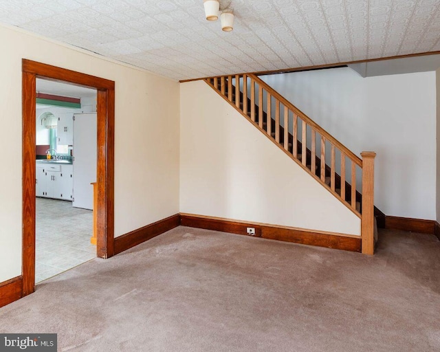 interior space with carpet flooring, stairway, and baseboards