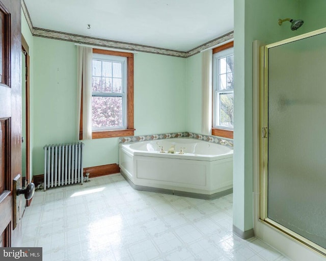 bathroom with tile patterned floors, a stall shower, and radiator heating unit
