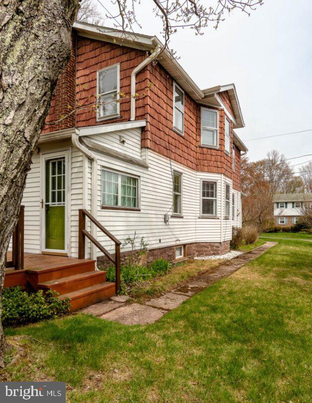 back of property featuring a lawn