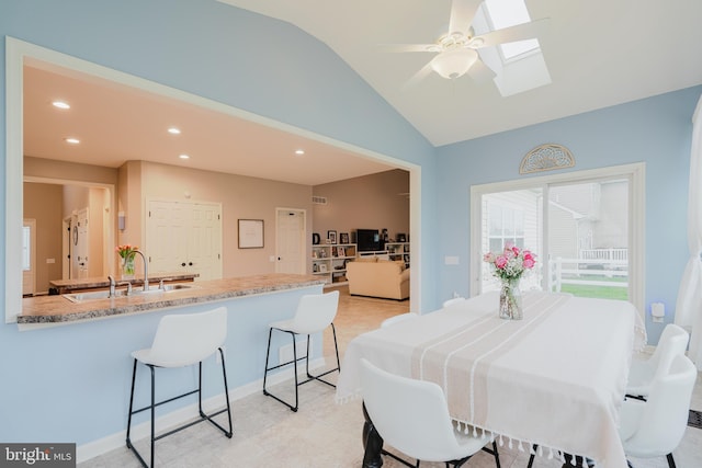 dining space with recessed lighting, ceiling fan, visible vents, and vaulted ceiling with skylight