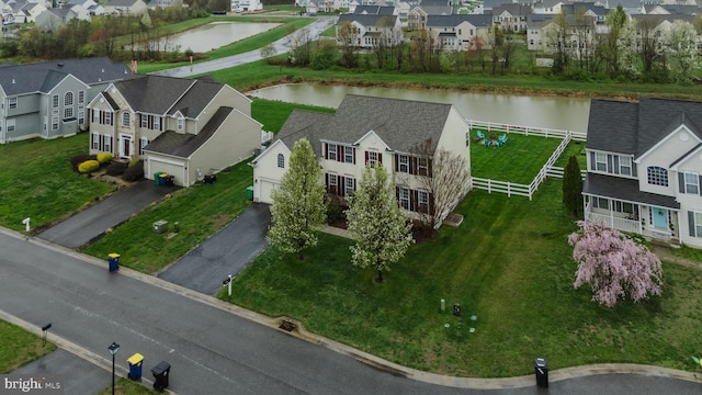 birds eye view of property featuring a water view and a residential view