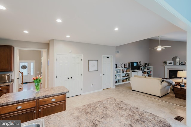 living area featuring ceiling fan, visible vents, a fireplace, light tile patterned floors, and recessed lighting