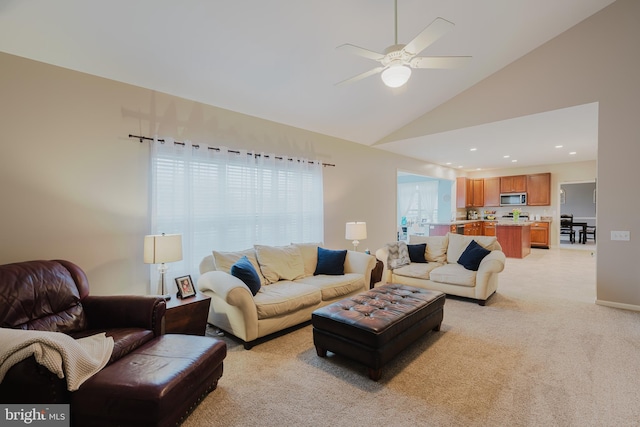 living area with recessed lighting, ceiling fan, light colored carpet, and high vaulted ceiling
