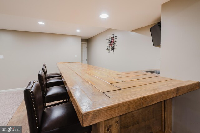 bar with recessed lighting, baseboards, and wood finished floors