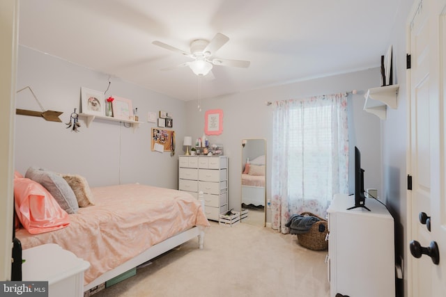 bedroom featuring a ceiling fan and light colored carpet