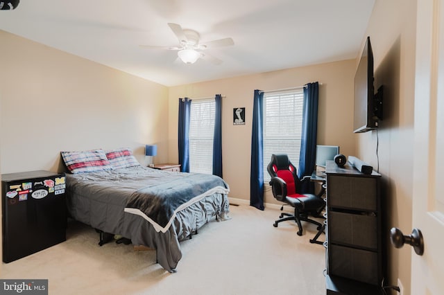 carpeted bedroom featuring baseboards and ceiling fan