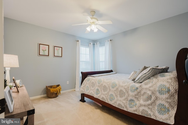 bedroom with baseboards, ceiling fan, and light carpet
