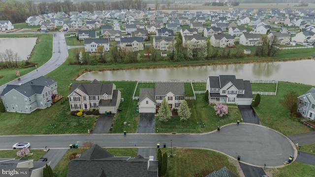 bird's eye view with a residential view and a water view