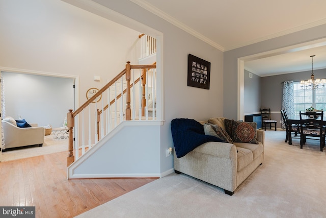 living area featuring crown molding, wood finished floors, baseboards, stairway, and a chandelier