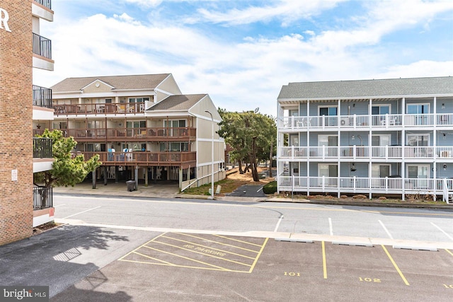 view of building exterior with uncovered parking