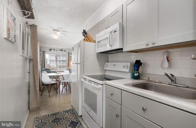 12 72nd St Unit 201, Ocean City, MD 21842 - kitchen featuring ceiling fan, a sink, white appliances, light countertops, and a textured ceiling