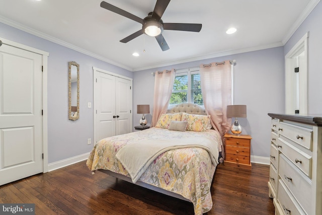 bedroom with crown molding, baseboards, dark wood-type flooring, and a closet