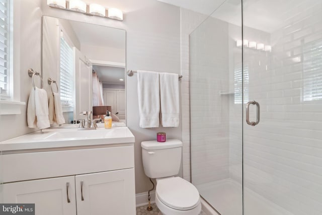 full bathroom featuring a shower stall, vanity, and toilet