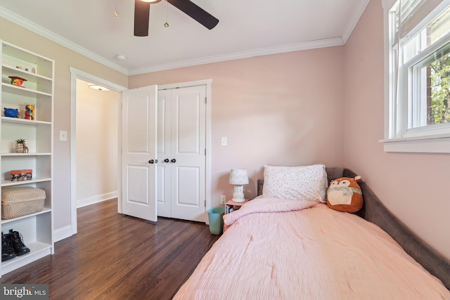 bedroom with baseboards, a closet, crown molding, and dark wood-type flooring