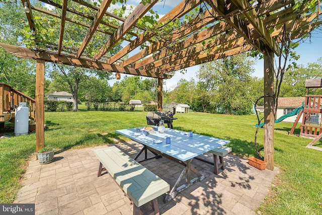 view of patio / terrace featuring outdoor dining space, a pergola, and a playground