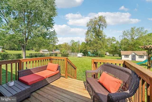 wooden terrace with a fenced backyard, an outdoor structure, a shed, and a lawn