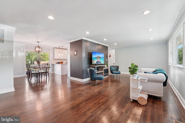 living area with a notable chandelier, wood finished floors, baseboards, and recessed lighting