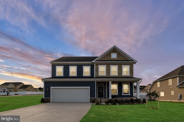 craftsman-style home featuring a porch, a front yard, a garage, fence, and concrete driveway