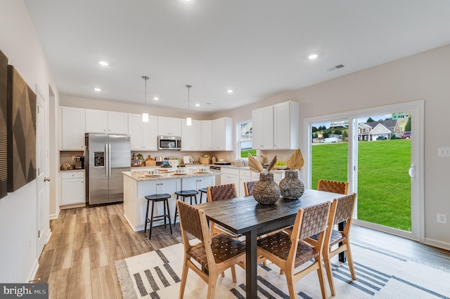 dining room featuring recessed lighting, visible vents, and light wood-style flooring