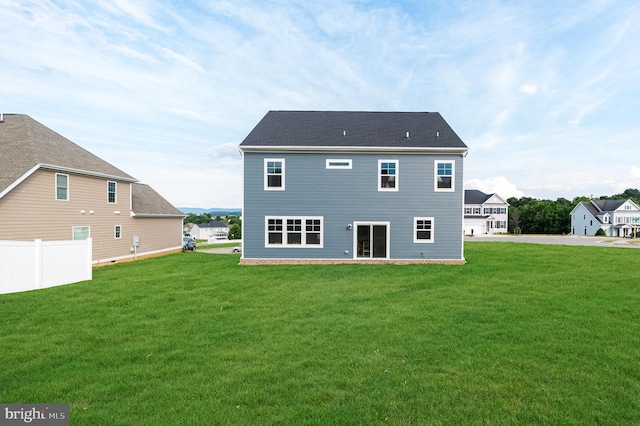 back of house featuring fence and a yard