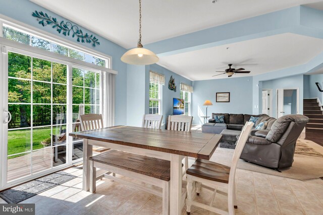 tiled dining room featuring stairs, a ceiling fan, and a wealth of natural light