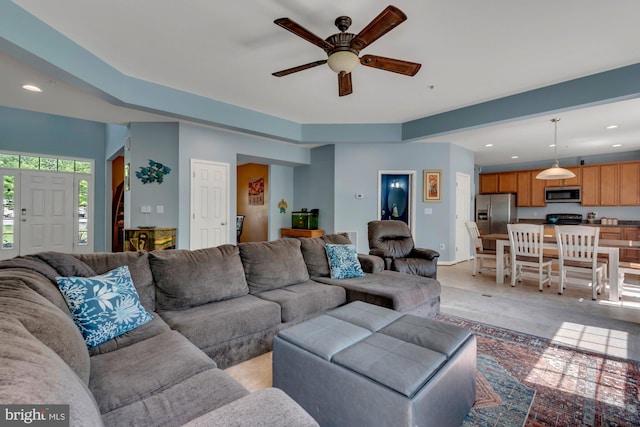 living area featuring recessed lighting, a ceiling fan, and baseboards