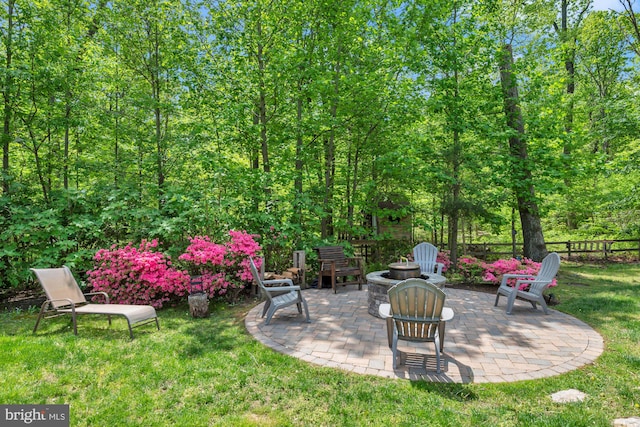 view of yard with a patio, an outdoor fire pit, and fence