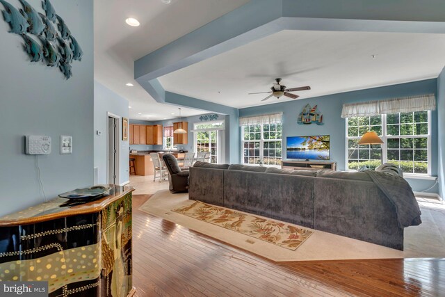 living area featuring a ceiling fan, recessed lighting, and light wood-style flooring