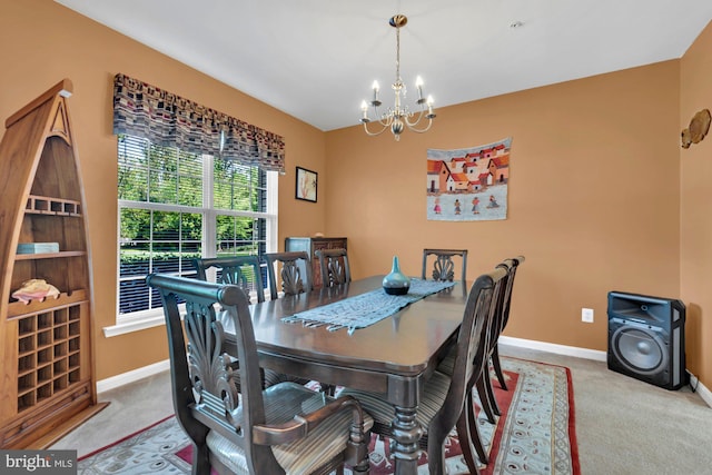 dining room with carpet floors, baseboards, and an inviting chandelier