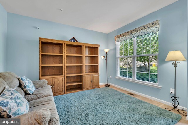 interior space featuring baseboards, carpet flooring, and visible vents