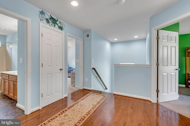 foyer featuring visible vents, recessed lighting, baseboards, and wood finished floors