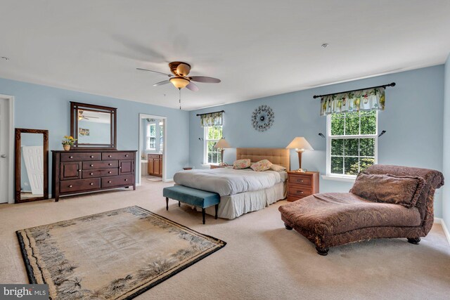 bedroom with carpet flooring, ceiling fan, and ensuite bathroom