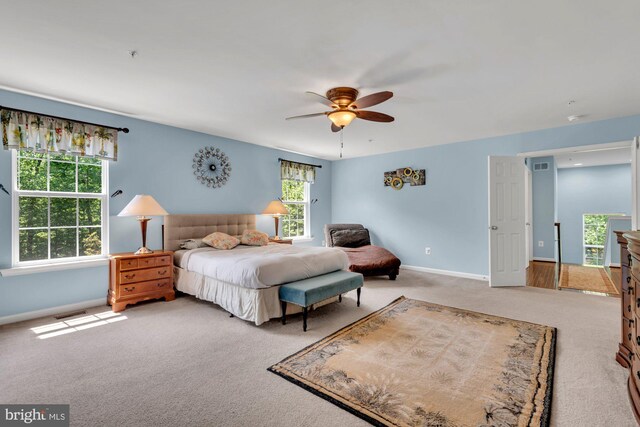 bedroom featuring a ceiling fan, baseboards, visible vents, and carpet