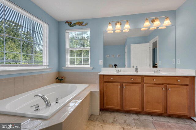 bathroom with double vanity, a sink, and a bath